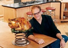 a man sitting at a table with a turkey on it