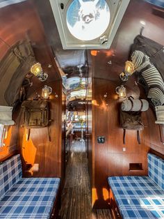 the inside of a train car with blue and white checkered seats on each side