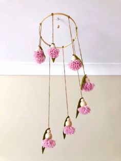 a pink flower mobile hanging from the ceiling