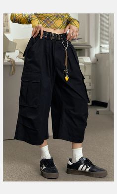 The EZEK Wide Leg Cargo Culottes are high-waisted, loose fit cropped pants featuring multiple pockets for practicality and style. Made from high-quality fabric, these culottes ensure comfort and durability. Perfect for casual wear or adding a trendy touch to your outfit, they offer a versatile and fashionable look. Fabric composition: 100% Nylon Model's measurements: Height 161cm, Weight 42kg, Bust/Waist/Hip 79/58/88, Wearing size M Black Wide-leg Cargo Pants For Summer, Black Wide-leg Summer Cargo Pants, Casual Black Wide Leg Pants With Pockets, Black Relaxed Fit Cropped Leg Capris, Black Cropped Wide Leg Summer Pants, Black Cropped Wide Leg Pants For Summer, High Waist Solid Color Baggy Capris, Baggy Cropped Leg Pants With Pockets, Summer Utility Pants With Cropped Leg