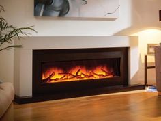 a living room with a couch and a fire place in the fireplace that is lit