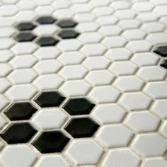 the black and white hexagonal tiles are arranged together