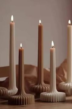 three candles sitting on top of a wooden table