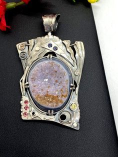 Artisan Gemstone Druzy Pendant Hand-made Sterling Silver. Stones used: Brazilian Druzy, Pink Tourmaline, Yellow Sapphire, Citrine,  Mystic Topaz. Height - 76mm, Width – 46mm.Unique Handcrafted One-of a-kind Design PendantEach Piece of Jewelry in my Collection is Absolutely One of a Kind!When you start wearing a piece of my jewelry you will fall in love with it more and more each day and feel that good Energy and Love that I pass into it while creating this piece of Art.A piece of Art created for Artisan Jewelry With Stones As A Gift, Unique Stone Jewelry As Gift, Unique Stone Jewelry For Gifts, Amulet Style Pendant Jewelry With Stones, Silver Pendant Jewelry With Stones, Unique Jewelry With Stones For Gift, Unique Oval Gemstones With Stone Setting, Artisan Jewelry With Large Stone Round Pendant, Artisan Silver Freeform Jewelry