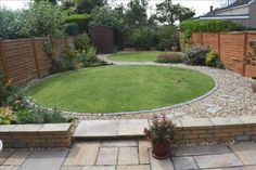 a small garden with grass and rocks in the middle