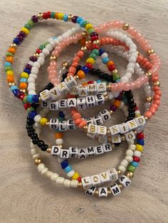 the beaded bracelets have words that spell out dream, love, and peace