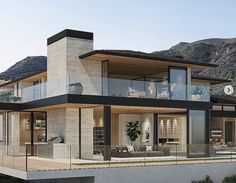 a large modern house in the middle of mountains