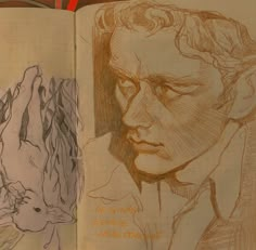 an open book with drawings on it and a drawing of a man's face