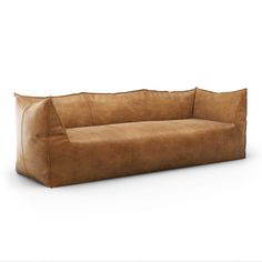 a brown leather couch sitting on top of a white floor