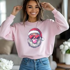 Holiday Order Deadline - December 10th. This Bubblegum Santa Sweatshirt combines a quirky, playful design with a cozy feel, perfect for adding some festive fun to your wardrobe. The Pink Christmas Vintage Sweater features a unique Retro Santa Claus blowing bubblegum, making it a standout piece for any holiday celebration. Whether you're attending a Christmas party, lounging at home, or shopping for a funny holiday sweatshirt, this Santa Sweatshirt adds a whimsical touch to the season. Made from Blowing Bubblegum, Bubble Christmas, Christmas Pullover, Christmas Apparel, Santa Sweatshirt, Retro Santa, Funny Santa, Funny Holiday, Holiday Sweatshirt