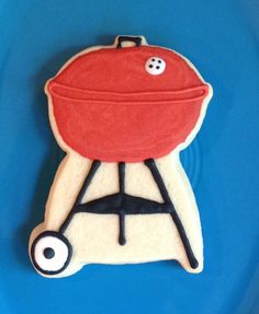 a cookie shaped like a bbq grill on a blue background