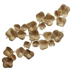 gold metal flowers are arranged on a white background with clippings for the petals