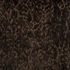 an animal print rug with brown and black colors