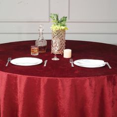 the table is set with two plates, silverware and a pineapple centerpiece