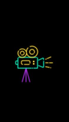 a neon sign with a camera on it's face and an arrow in the middle