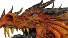 a close up of a dragon statue with its mouth open