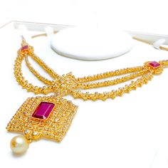 Crafted with exquisite attention to detail, this 22k yellow gold set weighs 54.8 grams and features a royal vintage design. It is adorned with uncut diamonds (Polki), totaling 11.18 carats, and further embellished with rubies and pearls, collectively weighing 34.2 carats. The set has a length of 16 inches, with an impressive drop length of 2.2 inches, and is secured with a hook lock and adjustable links for tailored comfort. The matching earrings, at a length of 2.1 inches, complete the set, eac Traditional Gold Pearl Necklace For Formal Occasions, Gold 22k Pearl Necklace For Wedding, Ceremonial Gold Kundan Necklace With Stone Work, Ceremonial Gold Kundan Necklace, Gold Kundan Necklace With Elegant Design For Formal Events, Gold Kundan Necklace With Elegant Design For Formal Occasions, Formal Gold Kundan Pearl Necklace, Ceremonial Gold Pearl Necklace In Temple Jewelry Style, Gold Pearl Necklace For Formal Festive Occasions