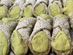 several pastries covered in powdered sugar and green icing