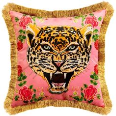 a pink pillow with a tiger on it's face and flowers around the edges