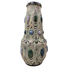 a ceramic vase with many different designs on it's sides, including circles and dots