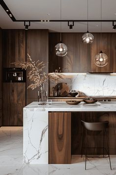 a modern kitchen with marble counter tops and wooden cabinetry, along with hanging lights