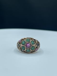 Discover the beauty of natural gemstones with this exquisite Handmade Natural Sapphire & Emerald 10k Yellow Gold Ring. This stunning piece is meticulously crafted to showcase a vibrant mix of pink and blue sapphires, complemented by lush emeralds. Perfect for any jewelry lover, this ring is a one-of-a-kind treasure. Features: *Ring Size: 7.75 *Materials: 10k yellow gold *Gemstones: Natural pink and blue sapphires, emeralds *Design: Intricate and unique, highlighting the beauty of each gemstone *Style: Handmade and one-of-a-kind This ring's intricate design and rich color palette make it a standout piece for any occasion. Whether you're treating yourself or looking for a special gift, this handmade ring is sure to impress. Fine Jewelry With Multi-stone Pink Sapphire, Multicolor Ruby Ring In Fine Jewelry Style, Multicolor Ruby Ring Fine Jewelry, Fine Jewelry Multicolor Rings With Rose Cut Diamonds, Multicolor Ruby Ring With Gemstone, Multicolor Round Ruby Ring, Luxury Multicolor Emerald Gemstone Ring, Multicolor Rose Cut Diamond Rings, Heirloom Multicolor Jewelry With Accent Stones