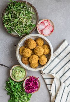 bowls filled with food sitting on top of a table next to other foods and vegetables