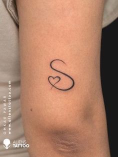 a woman's arm with a tattoo on it that has the letter s and is shaped like a heart