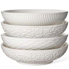 four white bowls stacked on top of each other