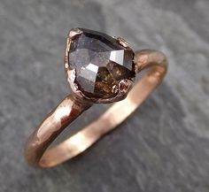 a close up of a ring with a stone in the middle on a rock surface