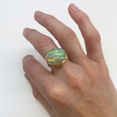 This claw set ring is a brand new design style in our collection. The star of the show is a beautiful Ethiopian Opal stone set in a four pronged claw setting. The underside setting of the ring features our classic Crownwork® grid pattern detail allowing the stone to shine from all angles. MATERIAL: 18k yellow gold STONE TYPE/CARAT WEIGHT: Opal 10.76cts DIMENSIONS: 14.8mm x 18.2mm Luxury Unique Opal Ring With Polished Finish, Gold Sterling Silver Opal Ring With Polished Finish, Luxury Opal Rings With Polished Finish, Cabochon Yellow Gold Opal Ring Collectible, Spiritual Hand-strung Opal Jewelry, Ancient Roman Coins, Swords Medieval, Ring Sale, Sapphire Pendant