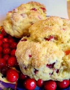 four pieces of scones with cranberry filling on a piece of parchment paper