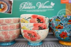 colorful bowls are on display in a store