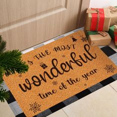 a door mat that says it's the most wonderful time of the year next to presents