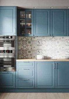 a kitchen with blue cabinets and wooden floors is pictured in this image, it appears to be an artist's impression