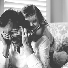 a man holding a woman on his back while they both look at each other's eyes