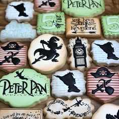 some decorated cookies are sitting on a table with black and white lettering in the middle