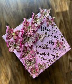 a pink graduation cap with butterflies on it and the words when you see me, i'm remember you planted my wings