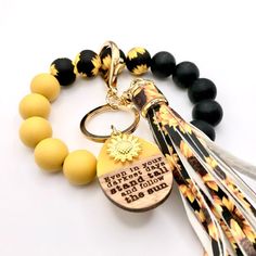 a keychain with a tassel and some beads on it that says, you can't touch the sun