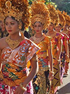 women in colorful costumes are walking down the street