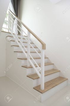 a white staircase with wooden handrails in an empty room stock photo - 787982