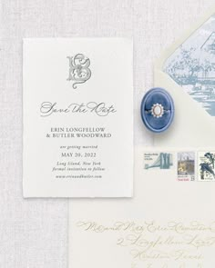 an envelope with a ring on it next to some stamps and a blue wax seal