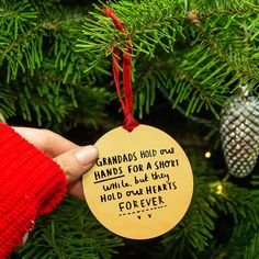 someone is holding up a christmas ornament that reads because someone is in heaven, a little piece of heaven is in our home