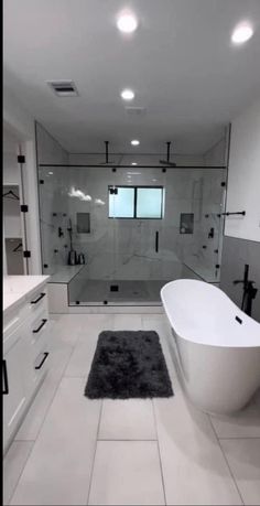 a large bathroom with a tub, sink and toilet