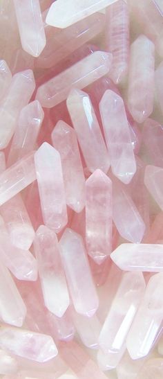 a bunch of pink rocks with a smiley face drawn on the middle one in black and white