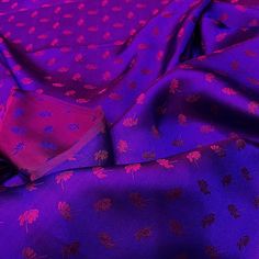 purple and red fabric with leaves on it