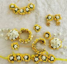 sunflowers and daisies are arranged on a white furnishing with yellow ribbons