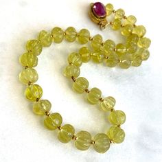 Elegant Yellow Faceted Gemstones, Formal Yellow Faceted Necklace, Yellow Gemstone Round Beads Jewelry, Yellow Gemstone Jewelry With Round Beads, Elegant Amber Gemstone Beads, Carved Yellow Gold Round Necklace, Classic Yellow Round Bead Jewelry, Carved Amber Round Beads Jewelry, Carved Yellow Jewelry For Gift