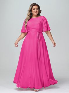 a woman in a bright pink dress posing for the camera with her hands on her hips