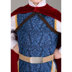 a young boy dressed in a blue and red costume with a white shirt, brown belt, and maroon cape